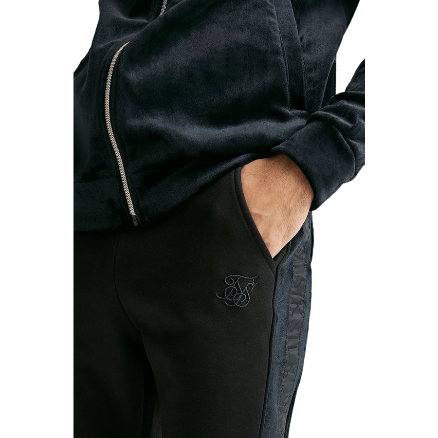 Pantalon noir à revers et bandes opulentes