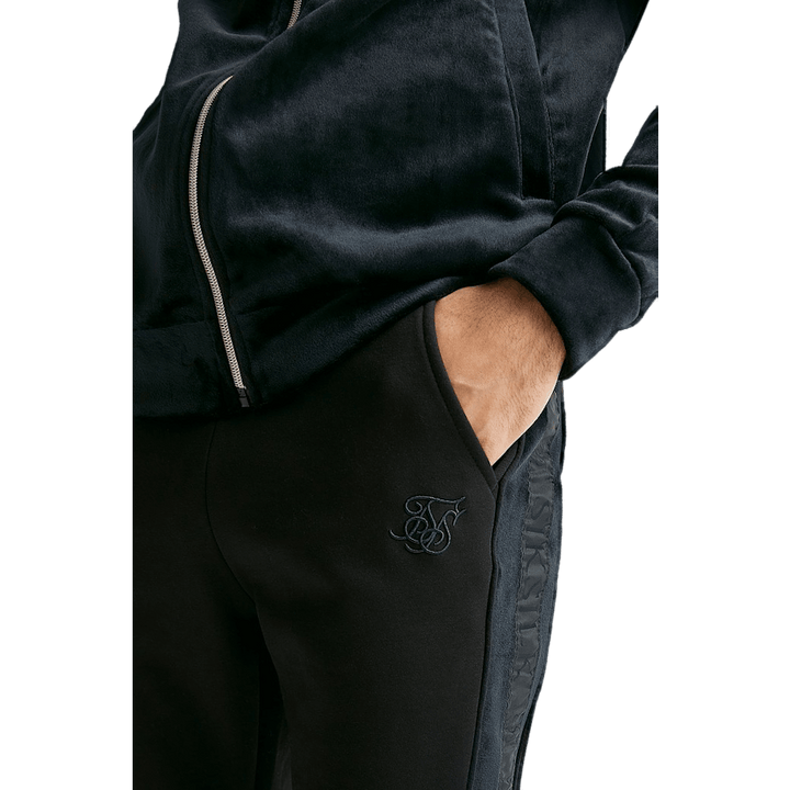 Pantalon noir à revers et bandes opulentes