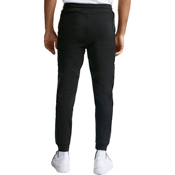 Pantalon noir à revers et bandes opulentes